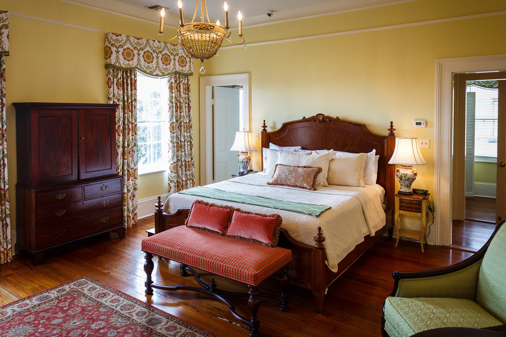 Design ideas for a large victorian master bedroom in Atlanta with yellow walls, dark hardwood flooring, a standard fireplace and a tiled fireplace surround.