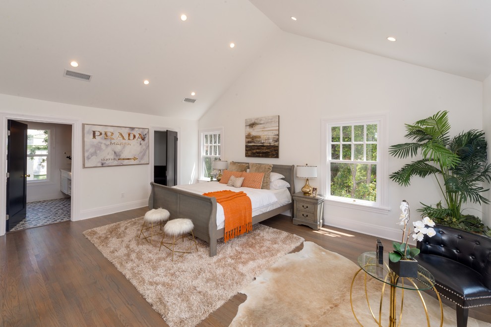 Transitional dark wood floor and brown floor bedroom photo in Los Angeles with white walls