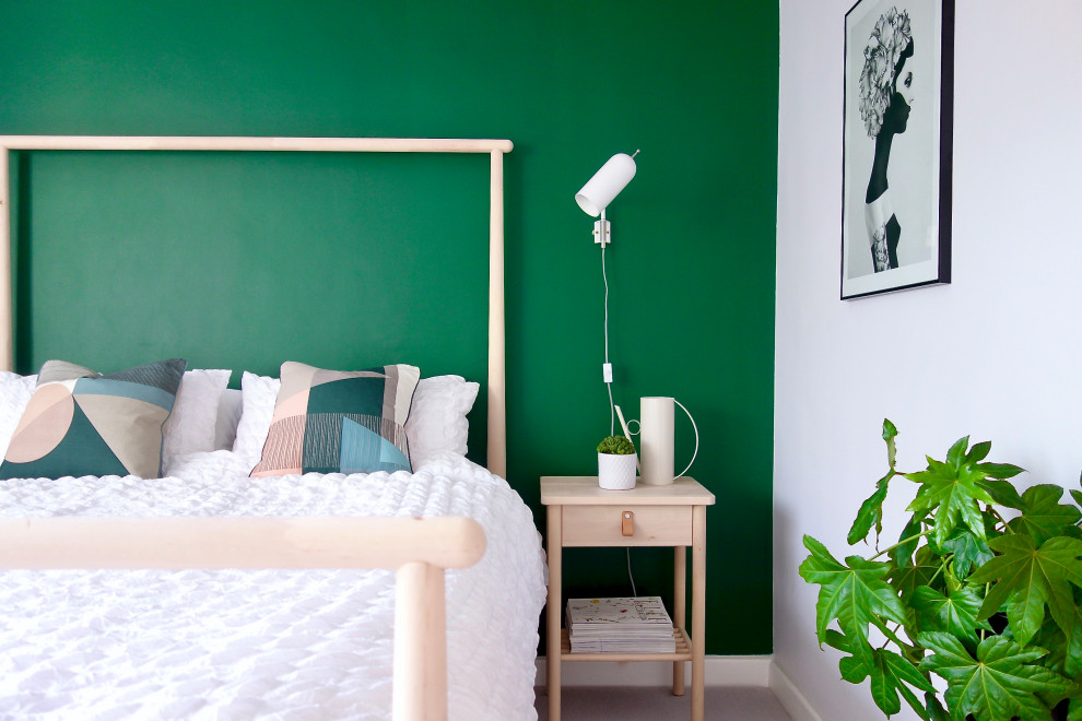 Photo of a medium sized scandinavian guest bedroom in Other with green walls, carpet and grey floors.