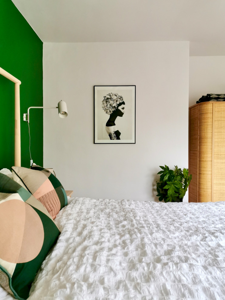 Photo of a medium sized scandi guest bedroom in Other with green walls, carpet and grey floors.