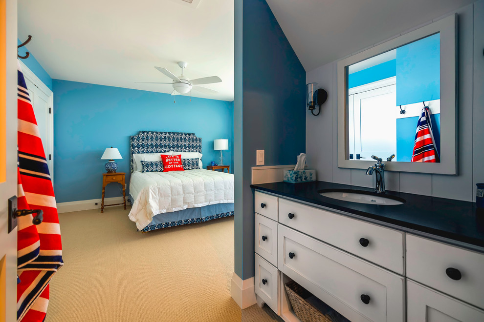 This is an example of a medium sized coastal guest bedroom in Toronto with blue walls and carpet.