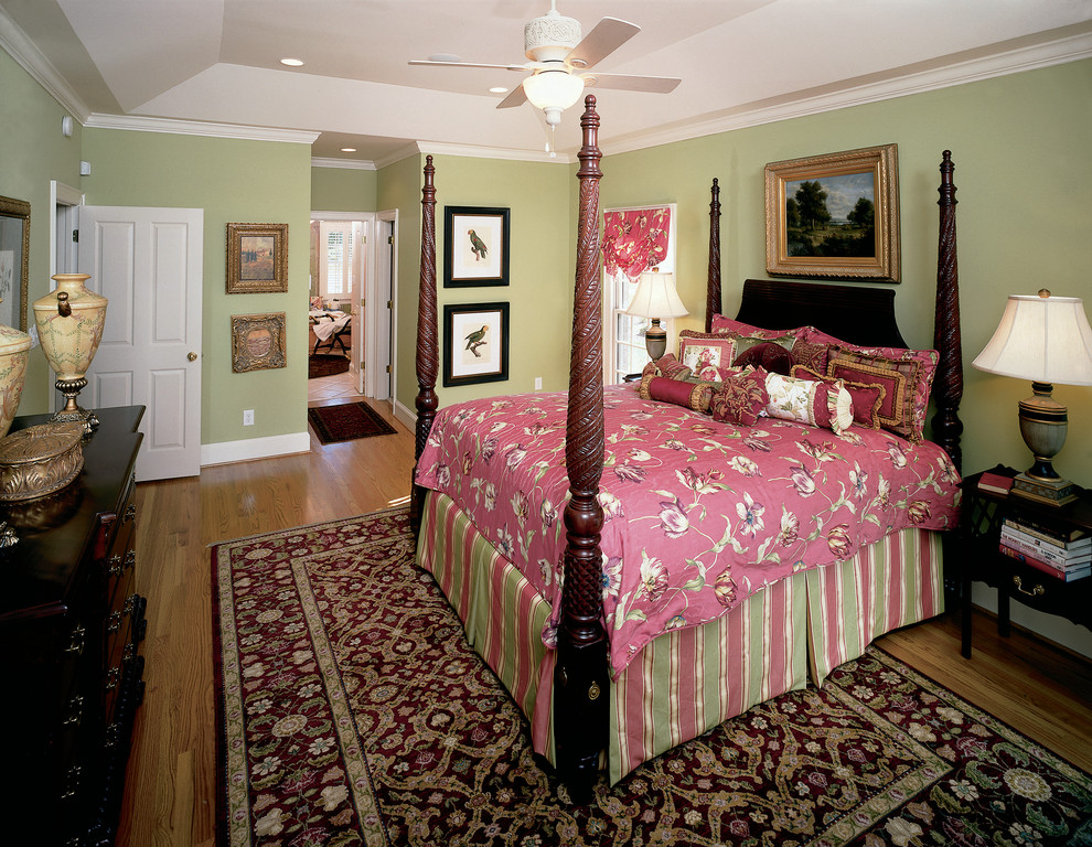 This is an example of an expansive classic master bedroom in Charlotte with green walls.