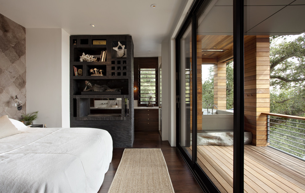 This is an example of a contemporary bedroom in San Francisco with dark hardwood flooring.