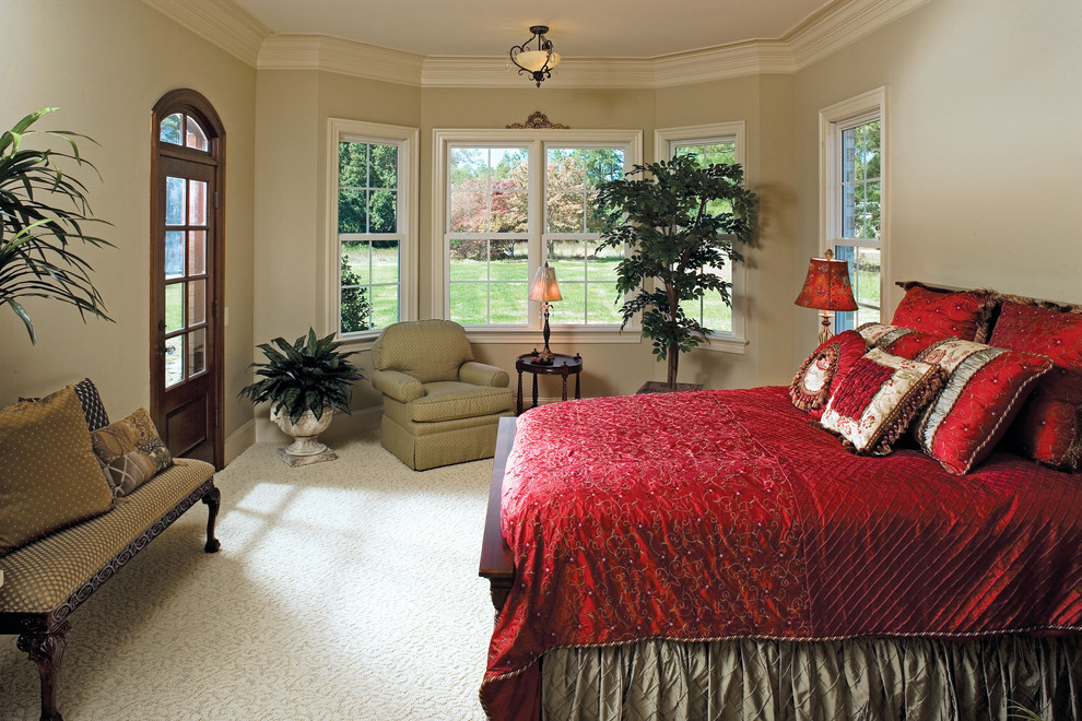 Example of a huge classic master carpeted bedroom design in Charlotte with beige walls and no fireplace