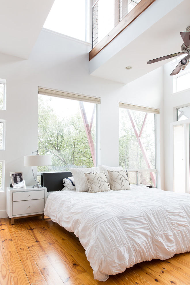 Inspiration for a country master bedroom in New Orleans with white walls and medium hardwood flooring.