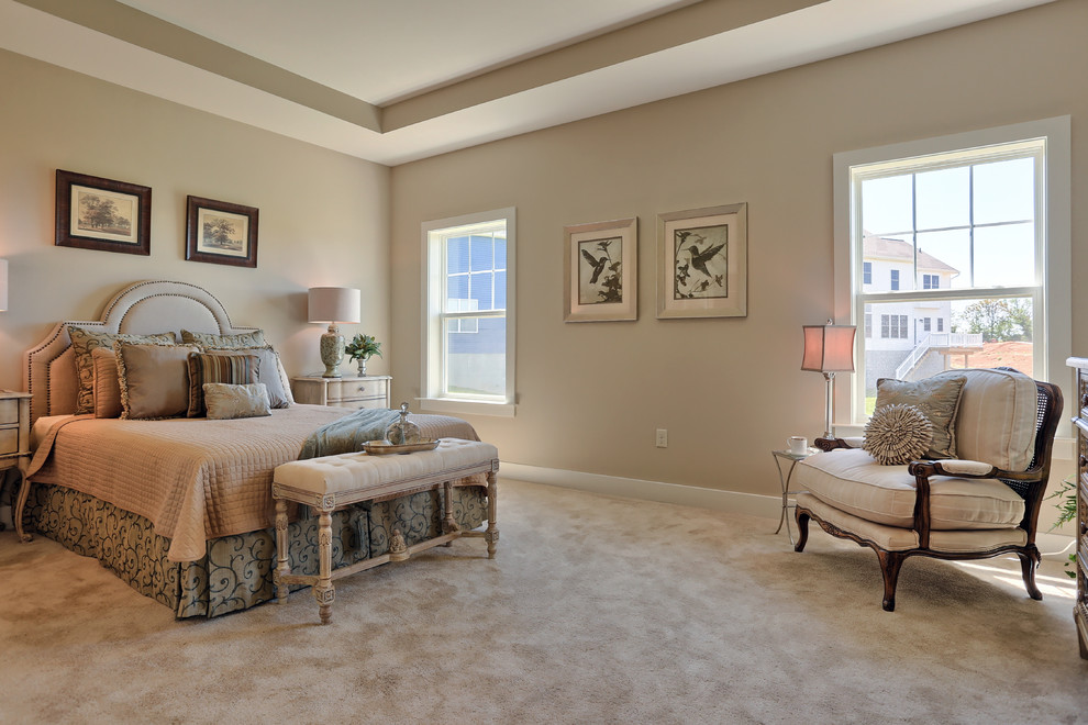 Photo of a large classic master bedroom in Other with beige walls, carpet and beige floors.