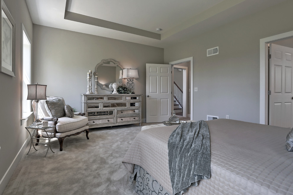 Inspiration for a large classic master bedroom in Other with beige walls, carpet and beige floors.