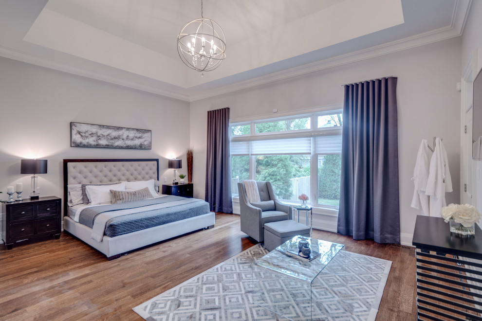 Inspiration for a classic master bedroom in Toronto with grey walls, medium hardwood flooring and brown floors.