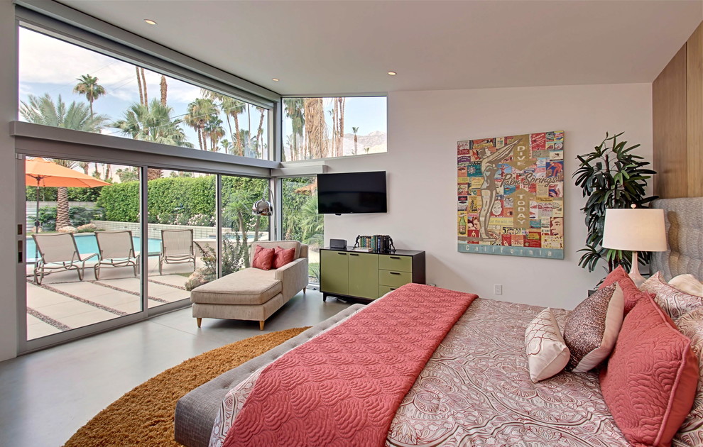 Example of a large 1950s master concrete floor bedroom design in Other with white walls