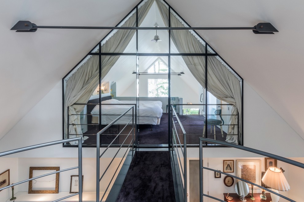 This is an example of a contemporary mezzanine loft bedroom in Boston with white walls, carpet and purple floors.