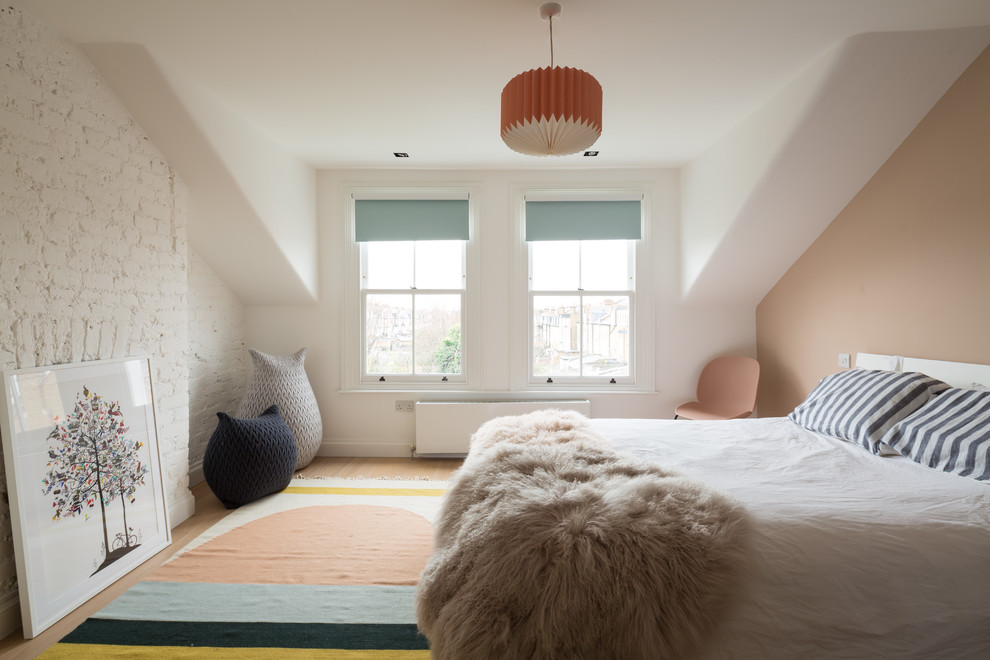 This is an example of a contemporary bedroom in London with white walls.