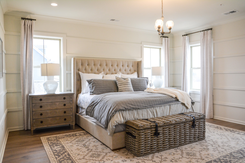 Example of a cottage medium tone wood floor and brown floor bedroom design in DC Metro with white walls