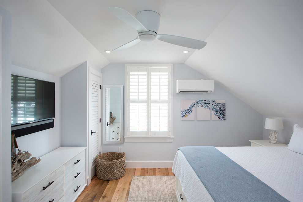 Bedroom - mid-sized coastal master medium tone wood floor and brown floor bedroom idea with blue walls