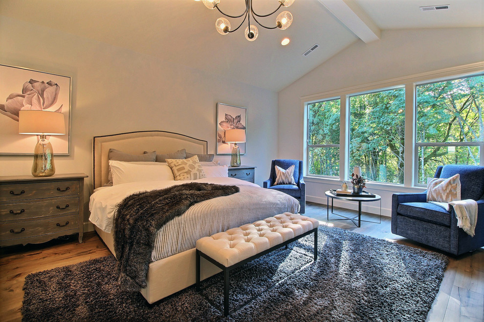 Expansive traditional master bedroom in Portland with beige walls, medium hardwood flooring, no fireplace and brown floors.