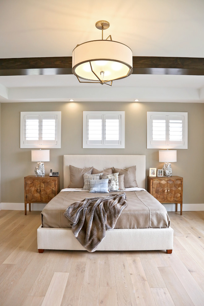 Photo of a large traditional master bedroom in Other with beige walls, light hardwood flooring, no fireplace and beige floors.