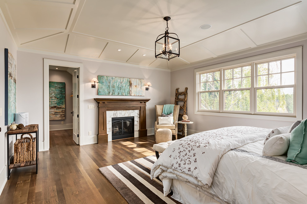 Foto de dormitorio principal de estilo americano de tamaño medio con paredes púrpuras, suelo de madera en tonos medios, todas las chimeneas y marco de chimenea de piedra