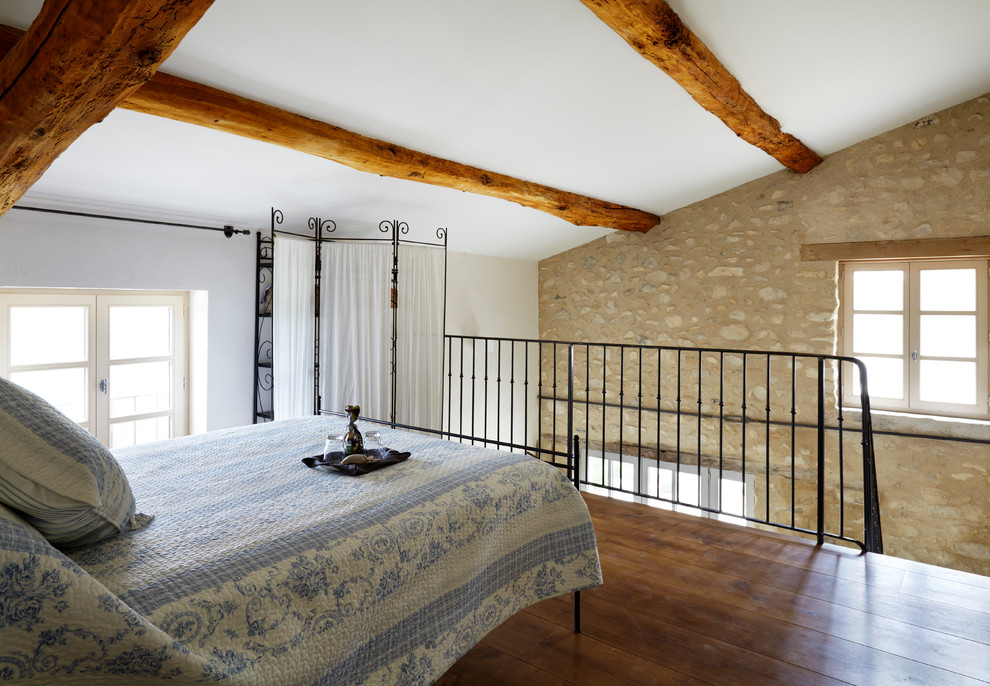 Example of a country loft-style bedroom design in Cheshire