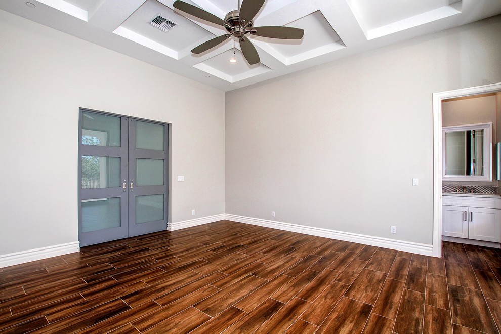 Example of a mid-sized transitional master dark wood floor and beige floor bedroom design in Phoenix with beige walls