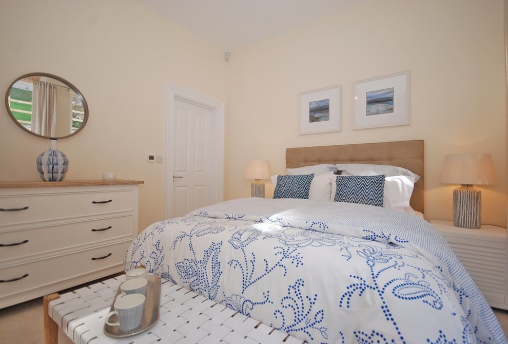 Photo of a medium sized beach style master bedroom in Devon with beige walls, carpet and beige floors.