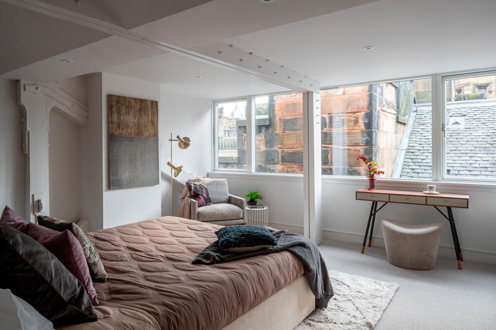 This is an example of a medium sized contemporary master bedroom in Glasgow with white walls, carpet and grey floors.