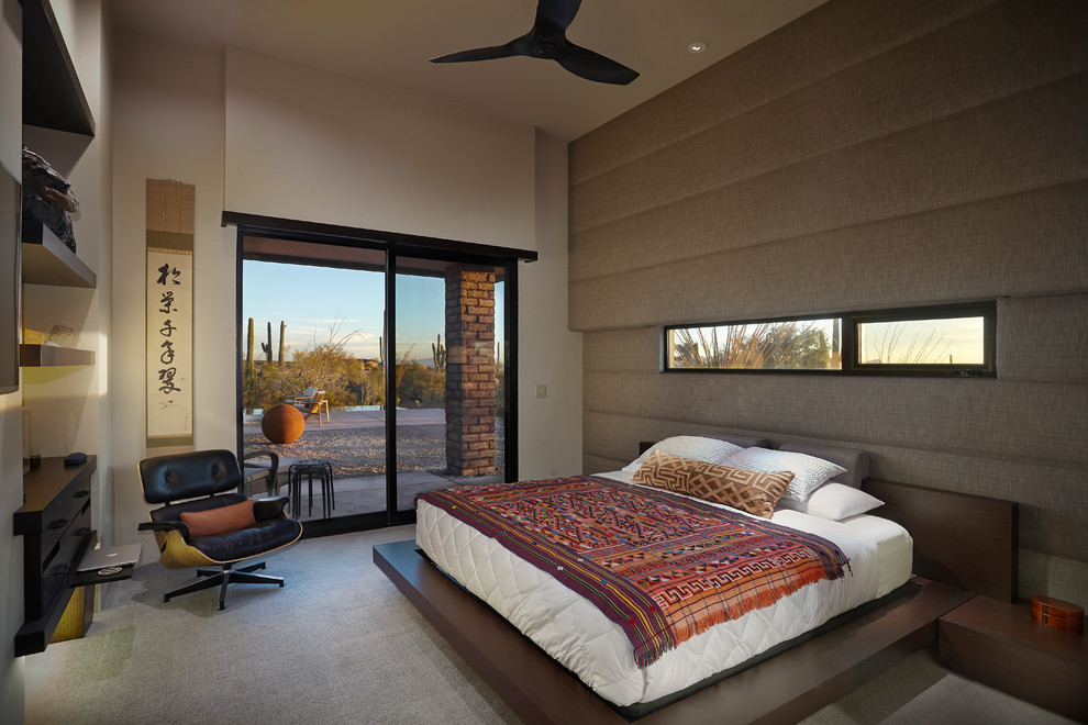 Example of a mid-sized master carpeted bedroom design in Phoenix with gray walls and no fireplace
