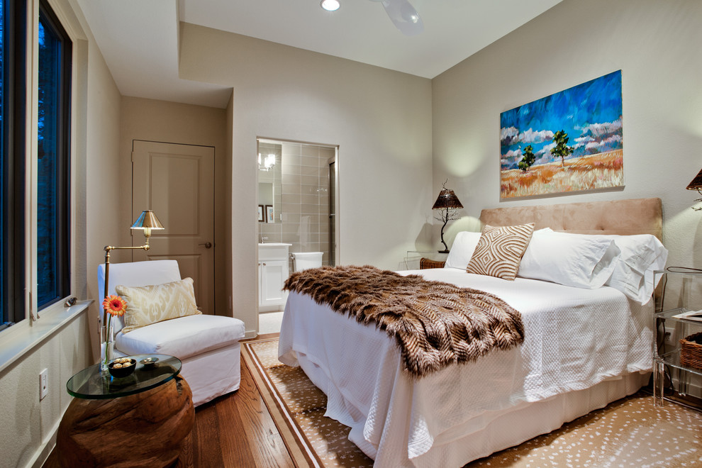 Mid-sized elegant guest medium tone wood floor bedroom photo in Dallas with no fireplace and gray walls