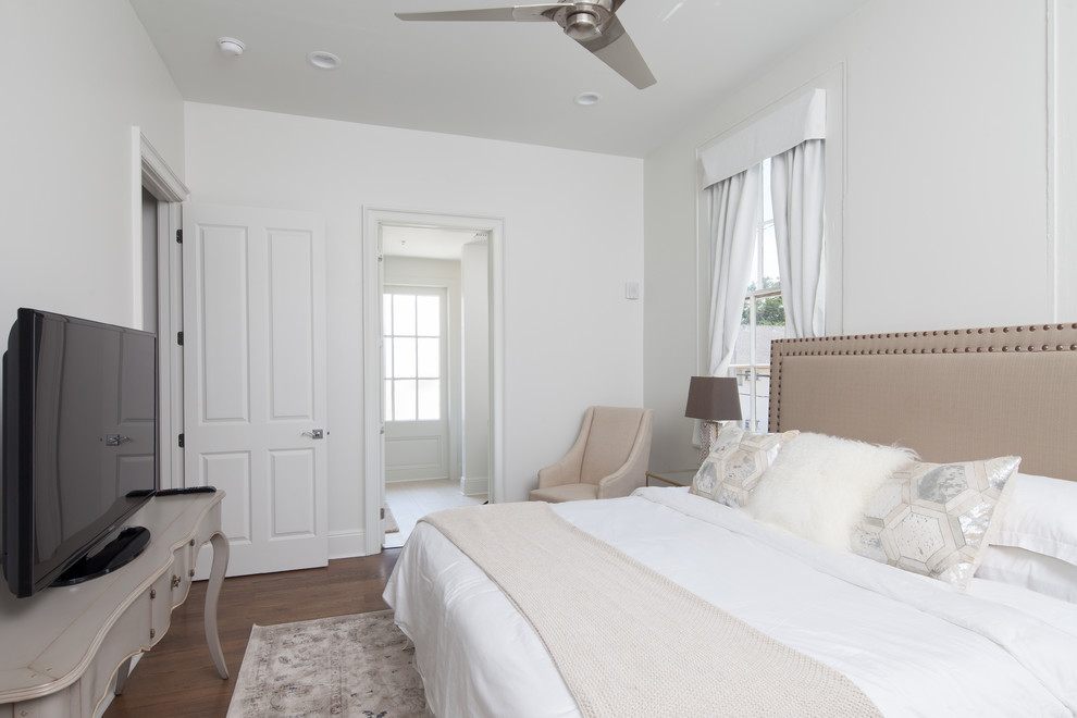 Diseño de dormitorio principal tradicional renovado de tamaño medio sin chimenea con paredes blancas y suelo de madera en tonos medios