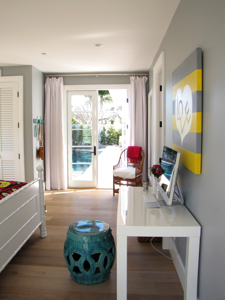 Example of a beach style bedroom design in Orange County with gray walls