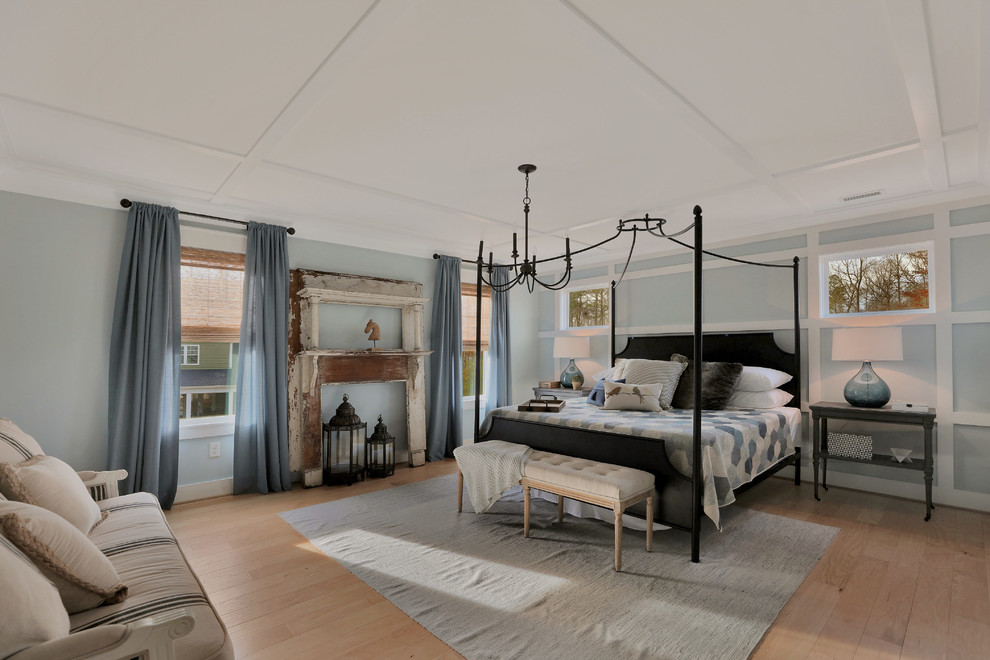 Example of a country master light wood floor and beige floor bedroom design in Richmond with blue walls