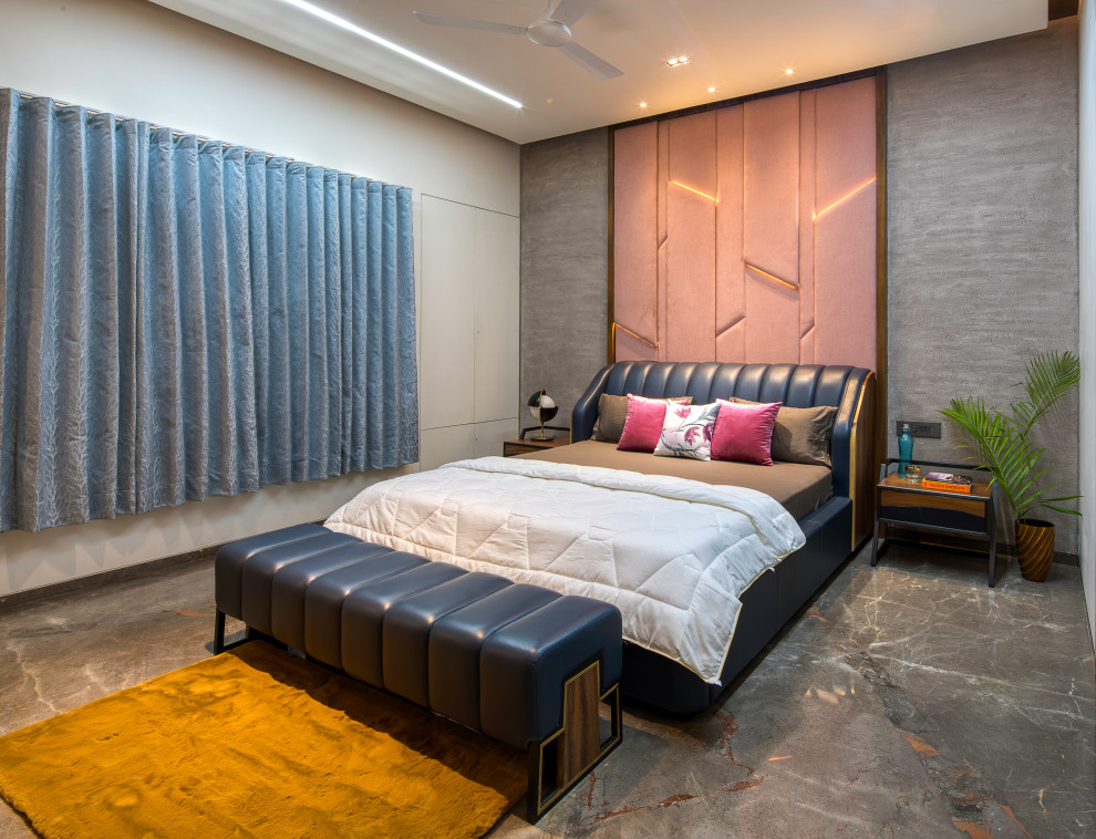 Contemporary bedroom in Ahmedabad with grey walls and grey floors.