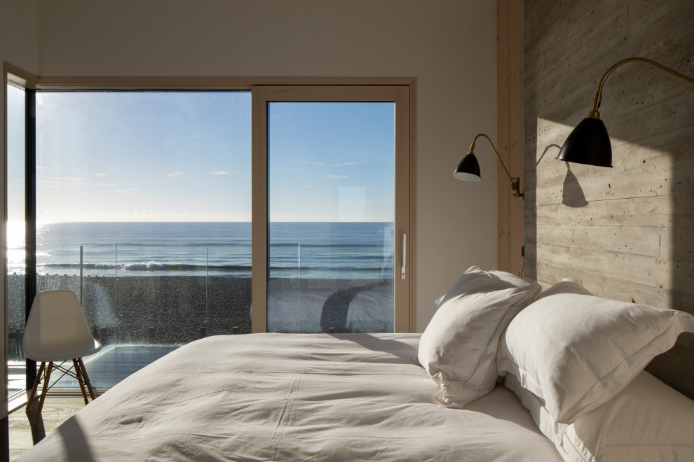 Bedroom - modern medium tone wood floor and brown floor bedroom idea in Sussex with gray walls