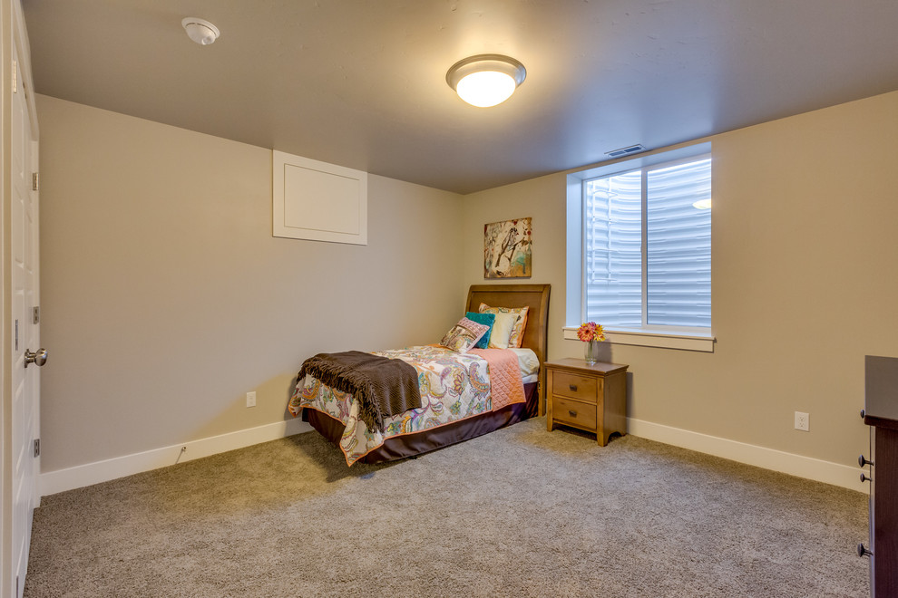Design ideas for a large contemporary guest bedroom in Boise with grey walls and carpet.