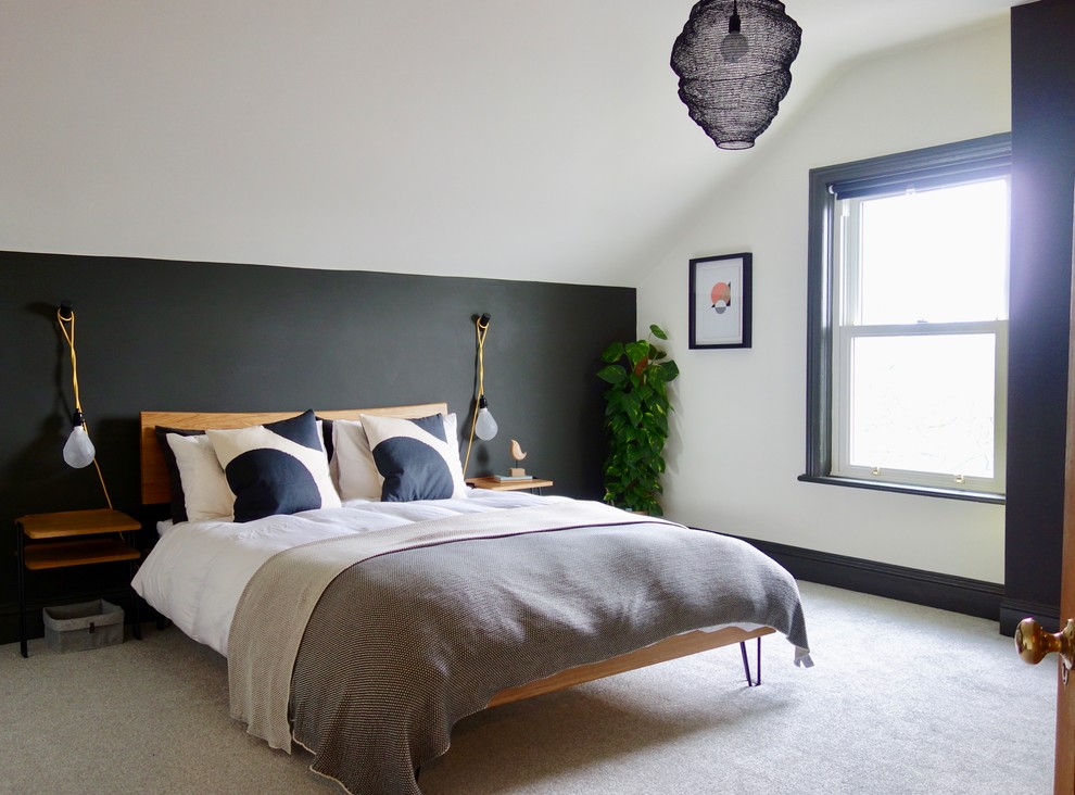 Large scandi guest bedroom in Other with white walls, carpet, a standard fireplace, a metal fireplace surround and grey floors.