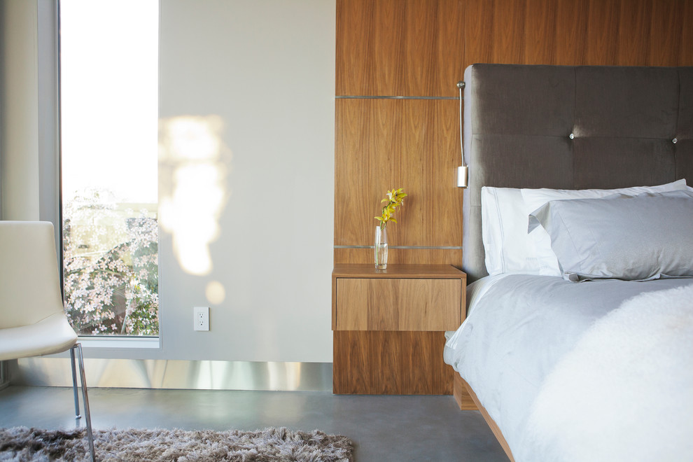 Bedroom - modern concrete floor bedroom idea in Vancouver with white walls