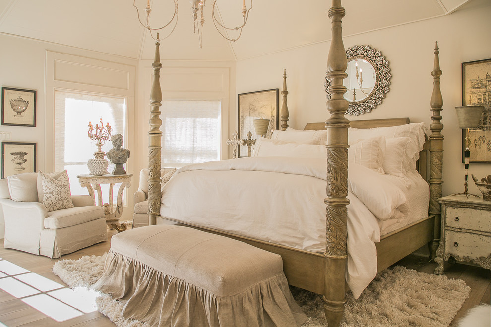 Photo of a shabby-chic style bedroom in Houston with white walls, medium hardwood flooring and brown floors.