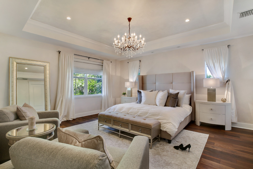Example of a large transitional master medium tone wood floor and brown floor bedroom design in Miami with gray walls