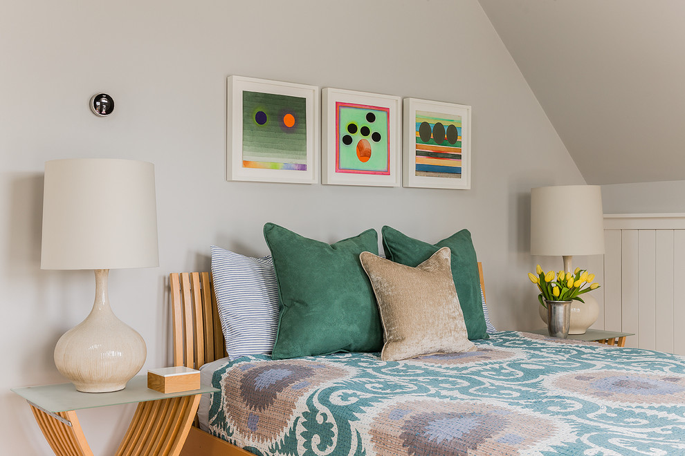 Design ideas for a medium sized scandinavian guest loft bedroom in Boston with grey walls and light hardwood flooring.