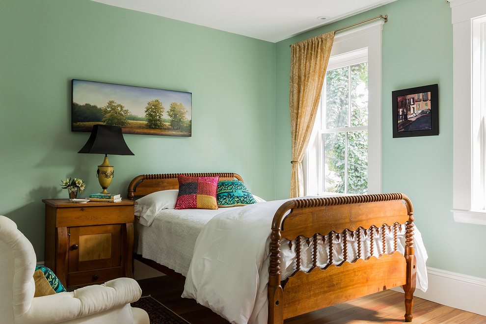 Example of a mid-sized classic guest medium tone wood floor and brown floor bedroom design in Boston with green walls
