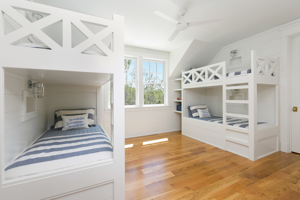 Mid-sized cottage guest medium tone wood floor and brown floor bedroom photo in Charleston with white walls and no fireplace