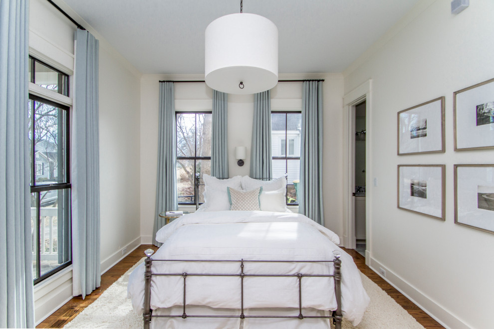 Inspiration for a mid-sized transitional guest medium tone wood floor and brown floor bedroom remodel in Little Rock with white walls