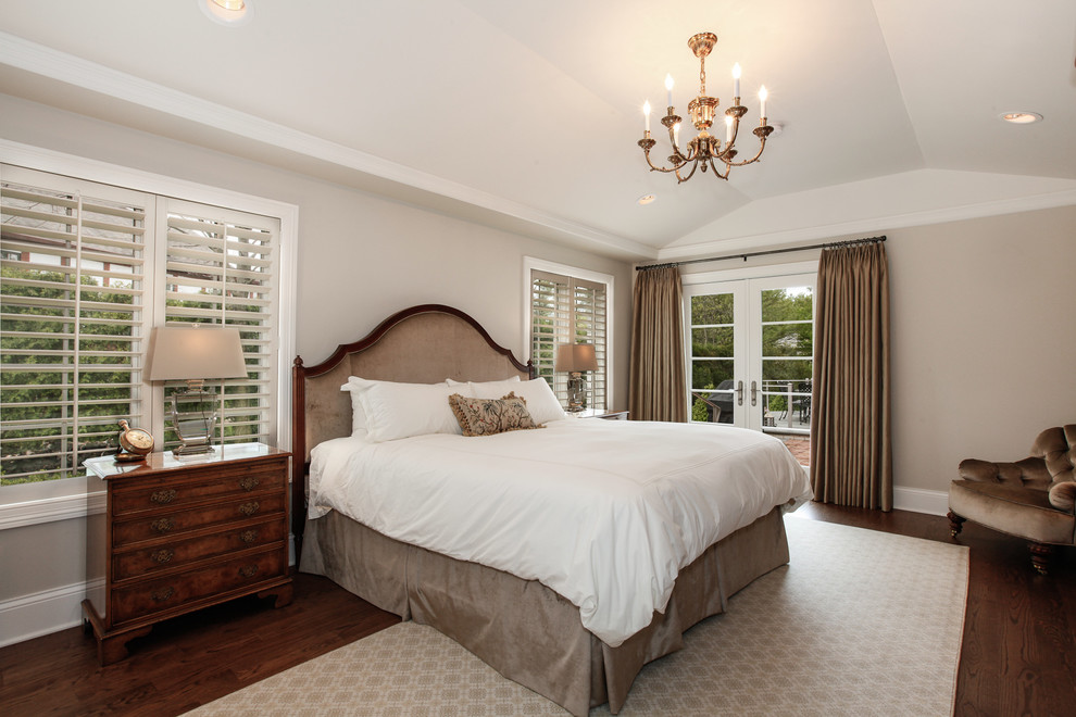 Large classic master bedroom in Chicago with grey walls, dark hardwood flooring and no fireplace.