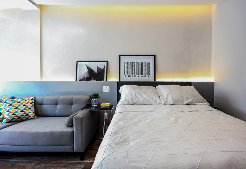 Imagen de dormitorio tipo loft contemporáneo pequeño con paredes grises, suelo de baldosas de porcelana y suelo marrón