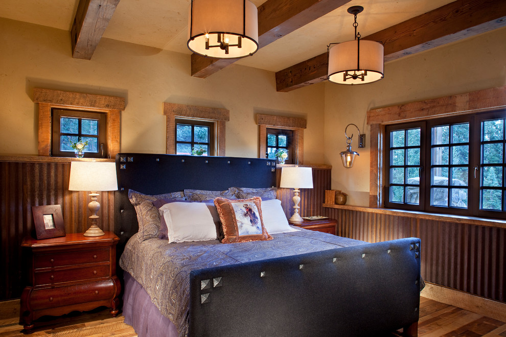 This is an example of a rustic guest bedroom in Denver with medium hardwood flooring.