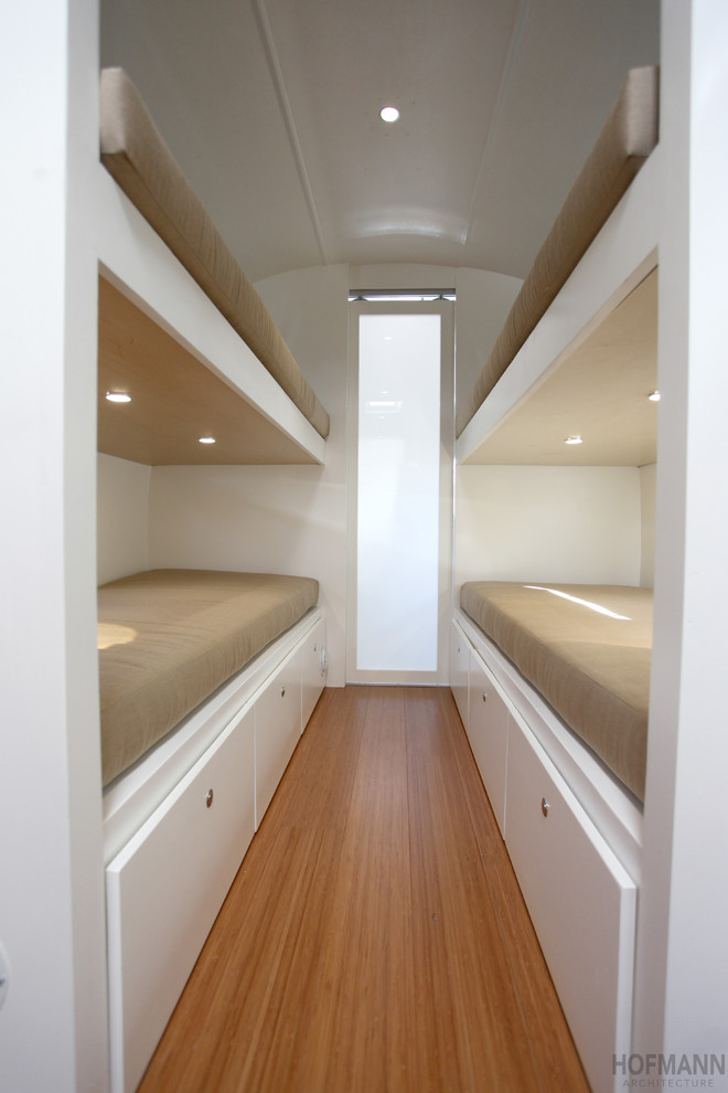 Small contemporary bedroom in Santa Barbara with white walls and bamboo flooring.