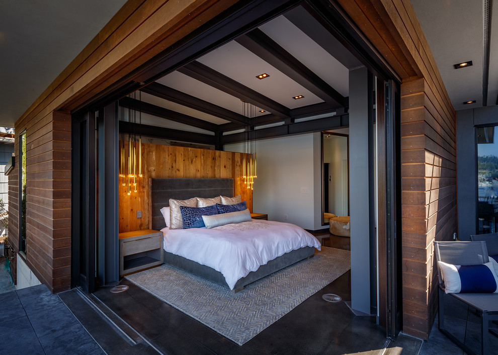 Diseño de dormitorio actual con paredes grises y suelo negro