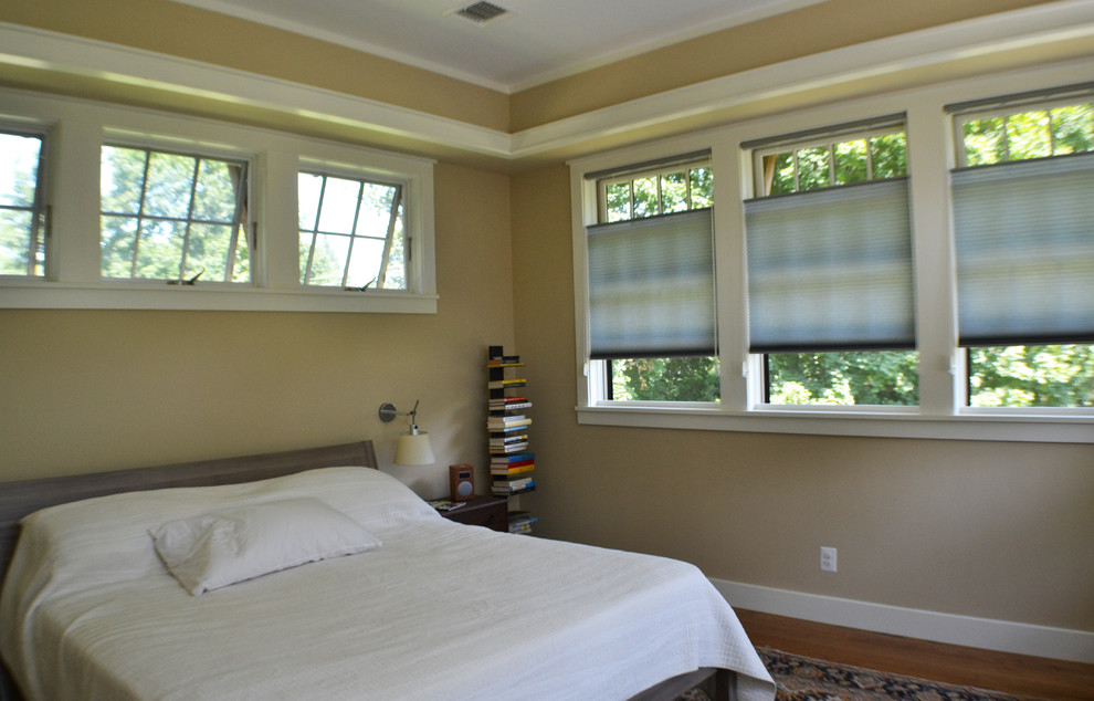 Example of a mid-sized arts and crafts master medium tone wood floor bedroom design in Philadelphia with beige walls