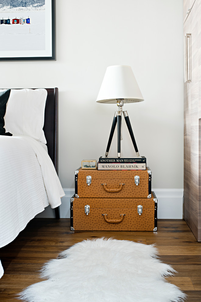 Bedroom - small contemporary master medium tone wood floor and brown floor bedroom idea in Raleigh with no fireplace and white walls