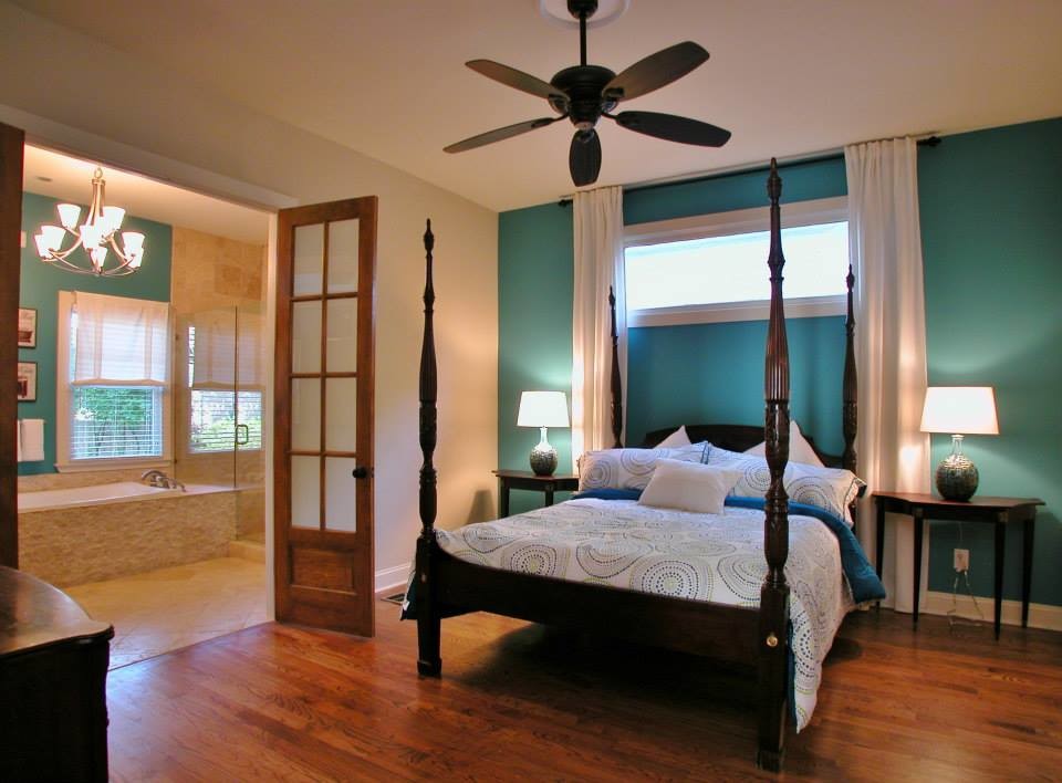 Ejemplo de dormitorio principal tradicional grande con paredes azules y suelo de madera en tonos medios