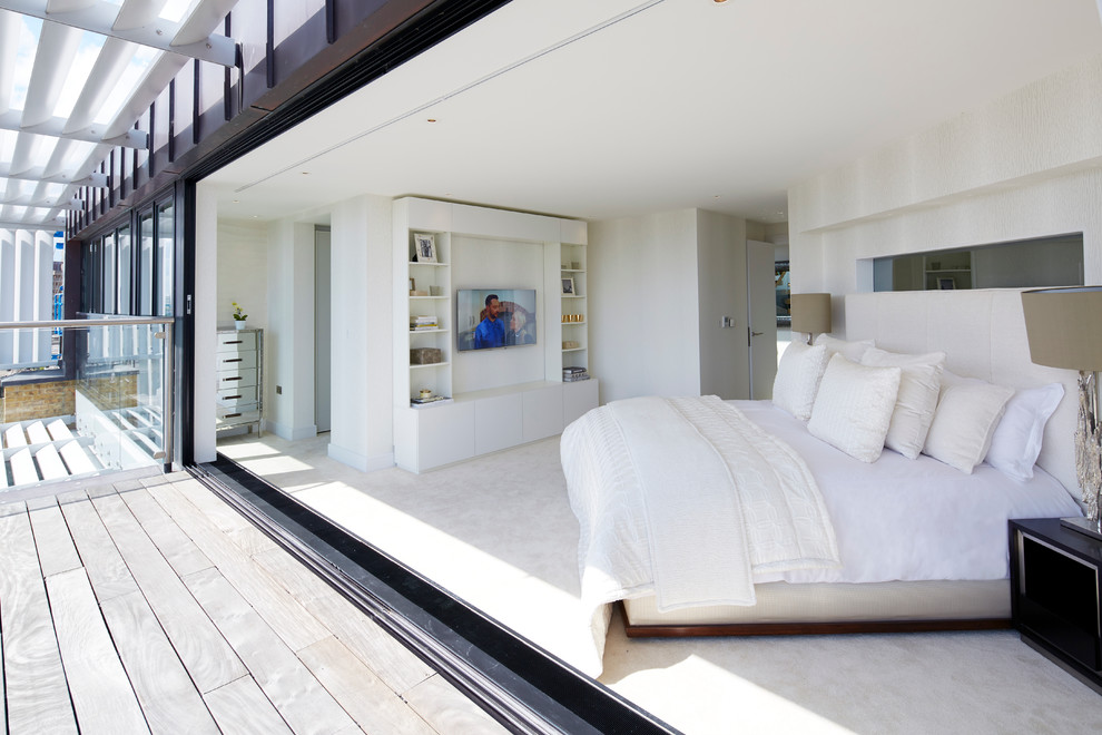 Design ideas for a contemporary master bedroom in London with white walls and carpet.