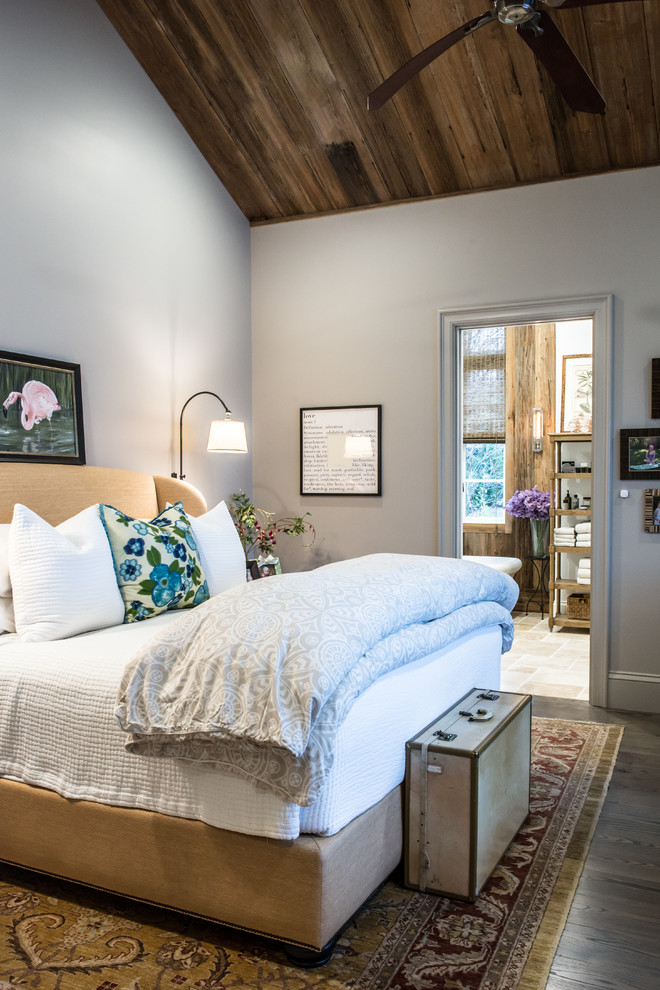 Design ideas for a large rustic master bedroom in St Louis with grey walls, no fireplace and dark hardwood flooring.